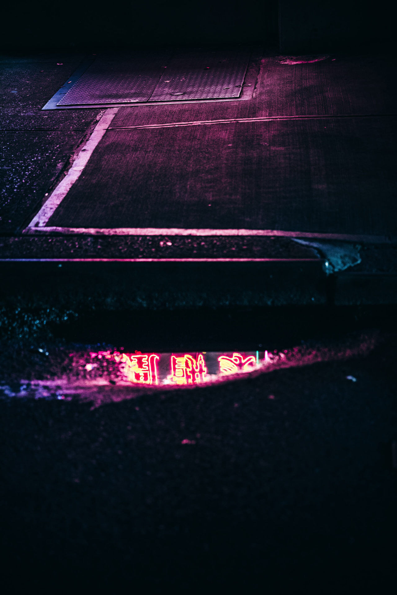 Reflection photo of neon light in puddle