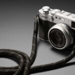 Limited edition Fujifilm X100VI with strap on grey background