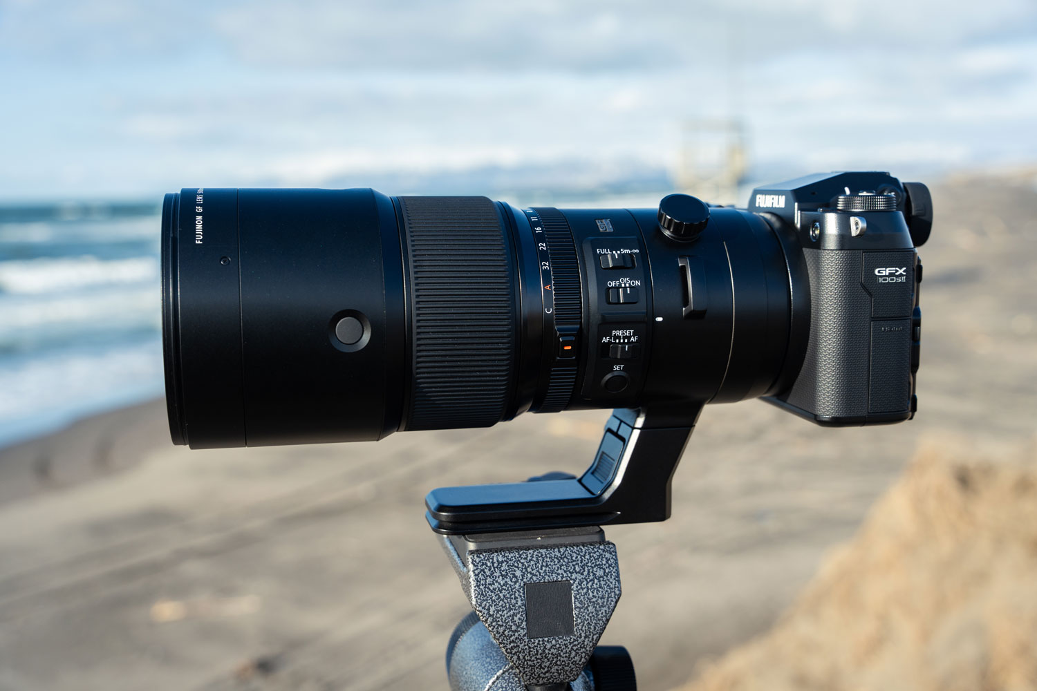 Fujifilm GFX100S II camera and GF500mm f/5.6 lens fixed to tripod in a beach setting